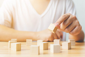 a teen boy plays with blocks at an autism treatment program in plano texas