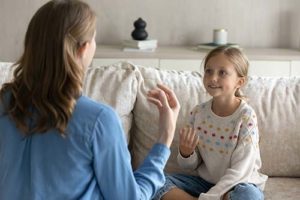 a mother and her autistic daughter practice skills learned through autism spectrum disorder treatment 